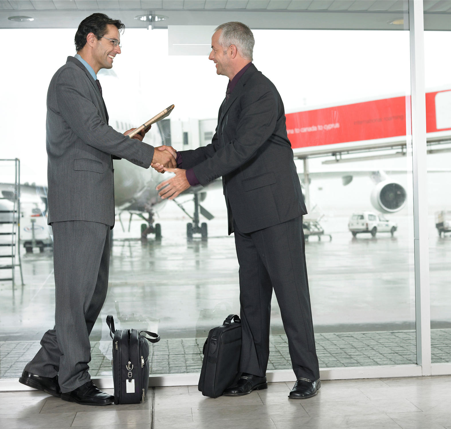 Two men meeting near airplane window